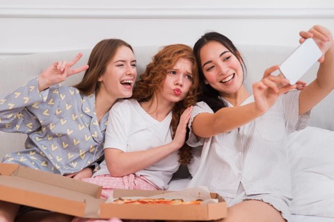 Playful girlfriends taking selfie