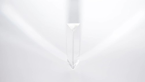 Prism dispersing sunlight white background