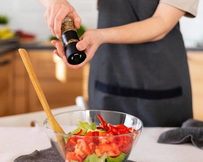 Close up hands spicing food