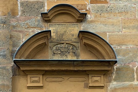 Former children's tomb with a poem above the side entrance of St Luke's Church