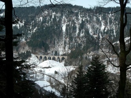 View from the Bister waterfall to the hairpin bends of the main road through the Hoellental valley and to the stone arch railway bridge over the Ravenna gorge