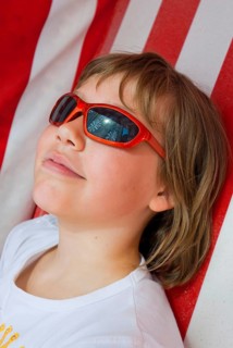 Young girl with sunglasses in beach chair