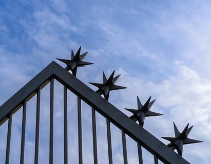 Metal fence with sharp-edged tops