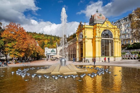 Spa colonnade with singing fountain in the autumnal spa park