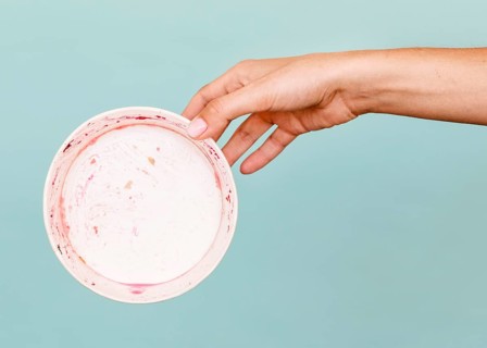 Close up hand holding dirty plate