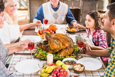 Happy family holding hands table
