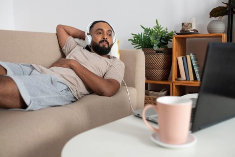 Medium shot man laying couch