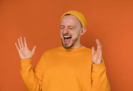 Happy young man laughing indoors 6