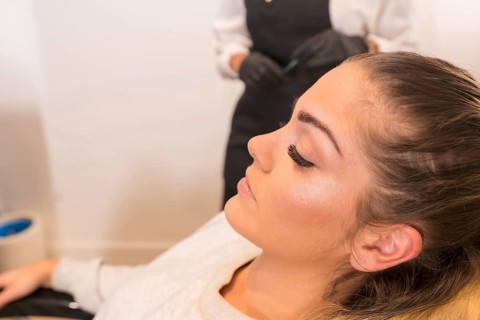 Close-up profile of a beauty woman sitting on a chair of a beauty salon