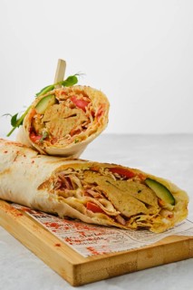 Rolled pita with falafel and vegetables cut on half