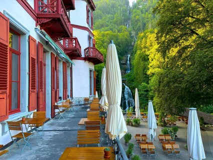 Grandhotel Giessbach with Terrace View over Giessbach waterfall in a Sunny Summer Day in Brienz
