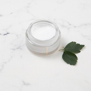 Body butter with leaves marble background
