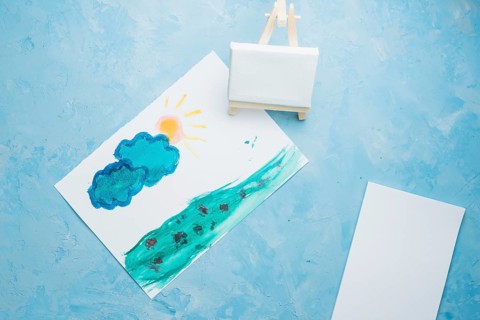 Hand drawn paper painting with mini easel watercolor backdrop