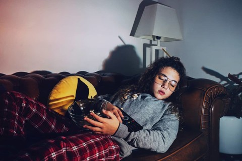 Girl sleeping with tv turned