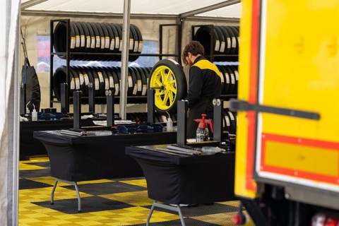 A Man Repairing a Tire of sportive motorbikes