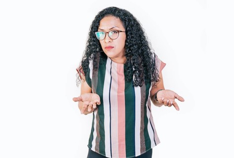Puzzled afro woman gesturing with hand isolated. Girl in glasses with puzzled face frowning. Puzzled people making hand gestures