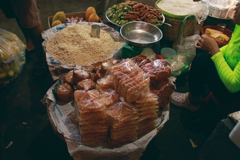 Authentic local khmer desserts sold in the traditional Samaki Market in Kampot Cambodia showing the candid daily life