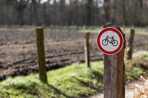 Warning sign no cycling on a country lane in the Duvenstedter Brook nature reserve