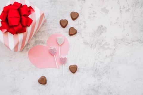 Lollipops near chocolate sweet candies paper heart present box