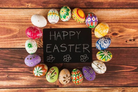 Easter eggs around paper with writing