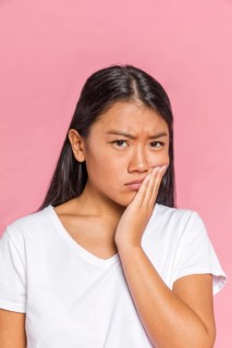 Black hair woman frowning looking camera