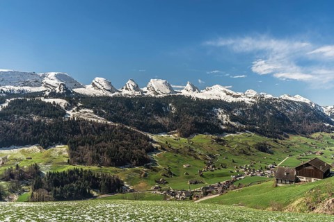 View of the snow-covered Churfirsten and the village of Alt St Johann