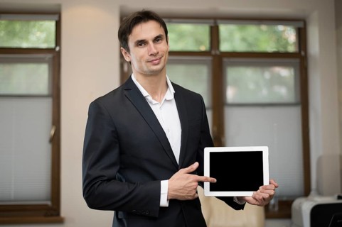 Medium shot businessman holding tablet