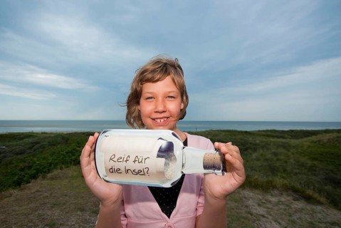 Child with message in a bottle