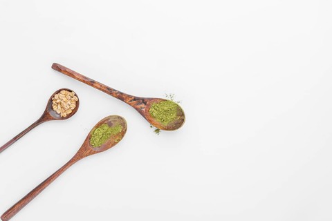 Close up spoons with matcha tea powder