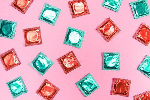 Flat lay condoms red green wrappers
