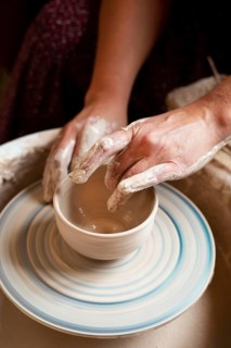 Person modeling clay potter s wheel