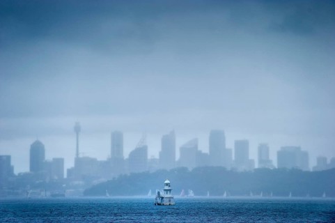 Skyline with lighthouse from Watson bay in the rain
