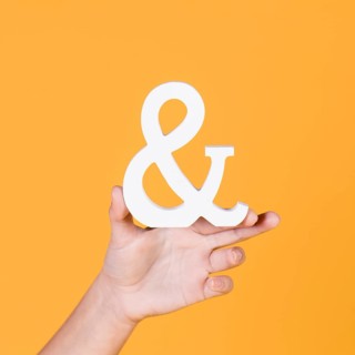 Woman s hand holding sign yellow background