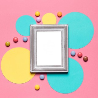 Empty blank frame with silver border circular frame with colorful gems pink background