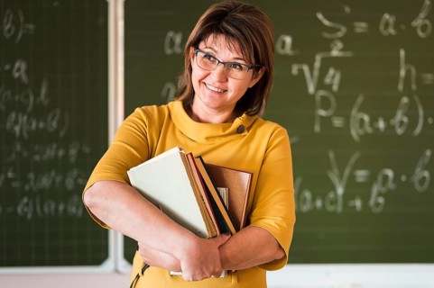 Front view teacher with stack books