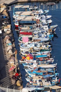 Numerous colourful fishing boats moored at the jetty