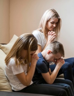 Front view family praying home