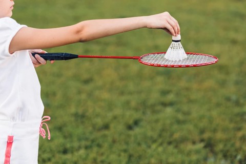 Close up girl playing badminton