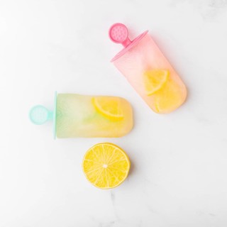 Cut lemon fresh ice popsicle with citrus colorful sticks