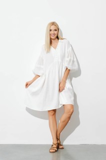 Portrait of happy stylish woman in white sundress indoors