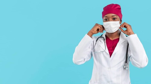 Female doctor adjusting her surgeon mask