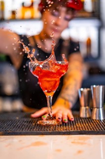 Vertical photo of a professional bartender preparing a Sex on the beach cocktail