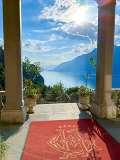 Grandhotel Giessbach Entrance with View over Lake Brienz and Mountain with Sunlight in a Sunny Summer Day in Brienz