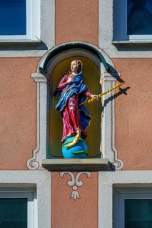 Facade with Madonna figure on globe with moon and snake
