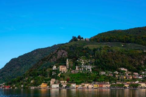 Beautiful Village Morcote witha Chucrh and Castle on Lake Lugano and Mountainscape with blue Clear sky in Morcote