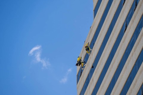 Window cleaner on a high-rise facade