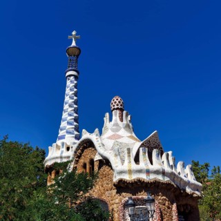 Mosaics decorate the tower and roof of a house