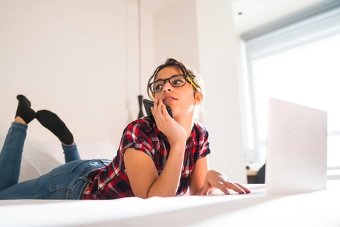Low angle view of a beauty distracted woman working from an hotel room