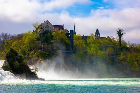 Rhine Falls and Swiss Flag with the Castle Laufen at Neuhausen in Schaffhausen