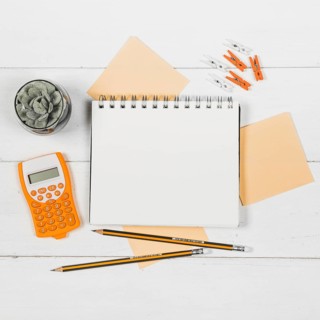 Flat lay notebook mock up surrounded by orange supplies